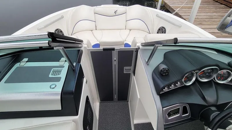 Slide: The Image of 2017 MasterCraft X23 boat interior with sleek dashboard and comfortable seating. - 12