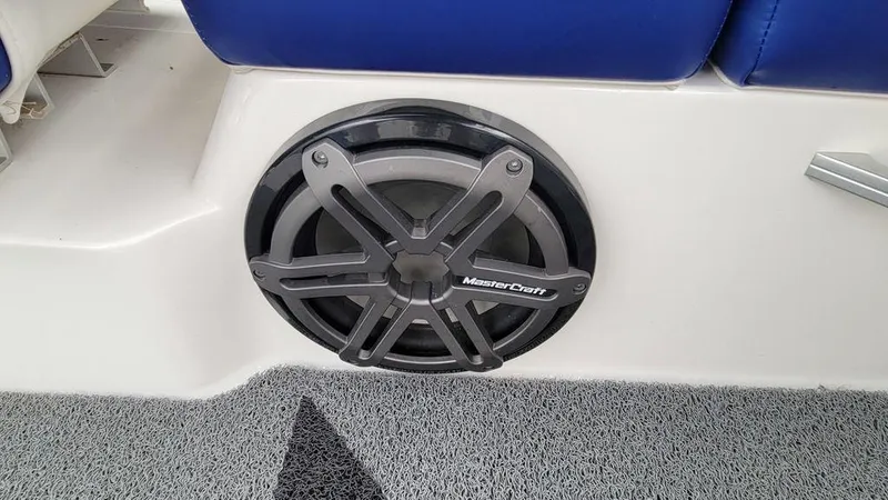 Slide: The Image of 2017 MasterCraft X23 boat speaker with blue seating and gray carpet. - 16