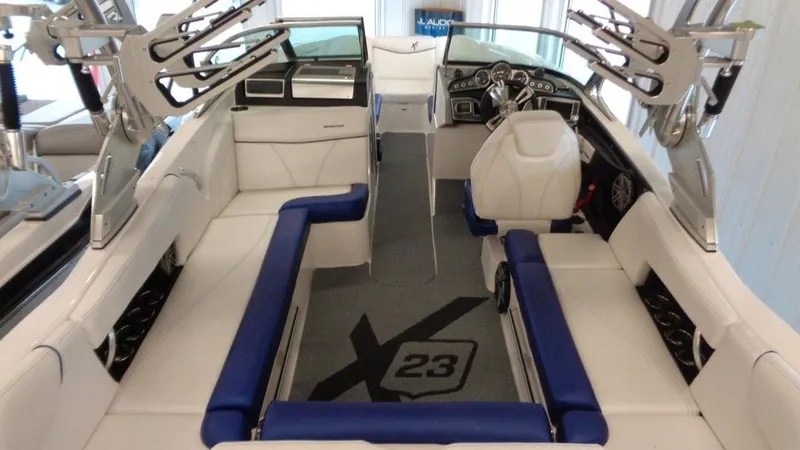 Slide: The Image of 2017 MasterCraft X23 boat interior with blue and white seating, sleek design. - 23