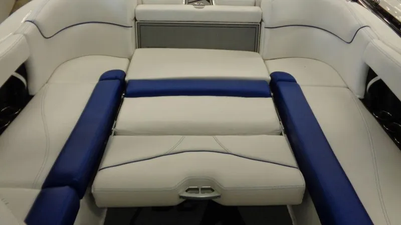Slide: The Image of 2017 MasterCraft X23 boat interior with white and blue seating arrangement. - 24