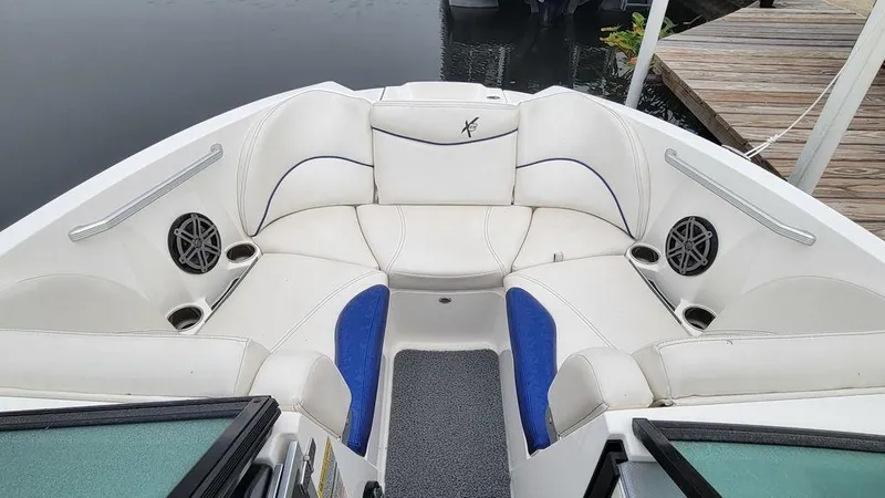 Slide: The Image of 2017 MasterCraft X23 boat interior with white seating and blue accents. - 25