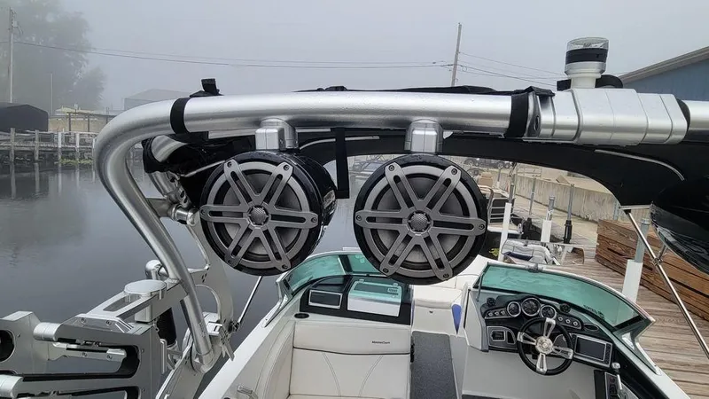 Slide: The Image of 2017 MasterCraft X23 boat with mounted speakers and sleek interior design. - 26