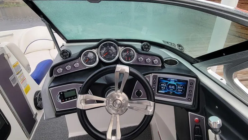 Slide: The Image of 2017 MasterCraft X23 boat dashboard with steering wheel and digital display. - 3