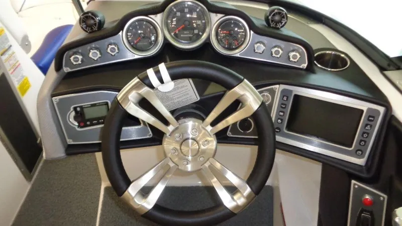 Slide: The Image of 2017 MasterCraft X23 dashboard with steering wheel and control gauges. - 30