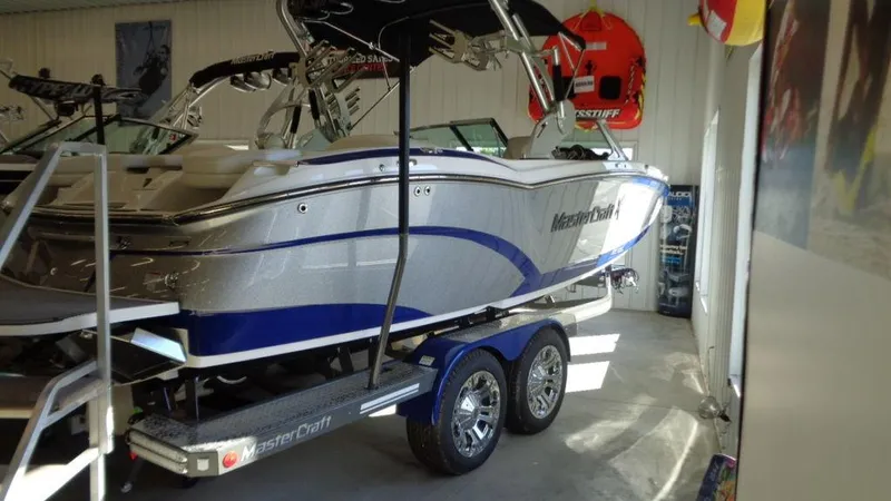 Slide: The Image of 2017 MasterCraft X23 boat on trailer in showroom. - 35