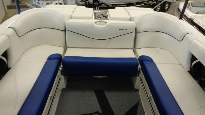 Slide: The Image of 2017 MasterCraft X23 boat interior with white and blue seating. - 36
