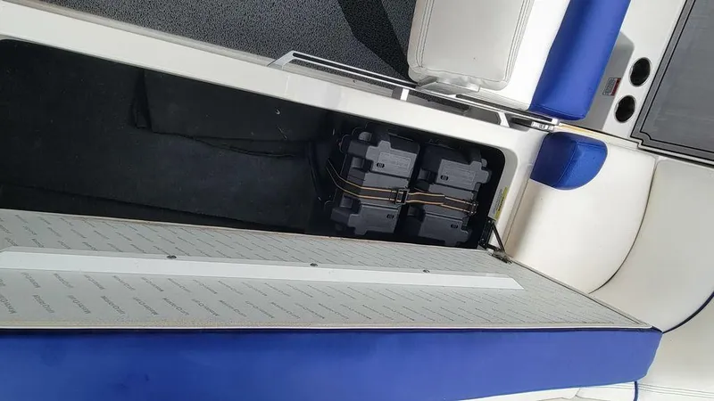 Slide: The Image of 2017 MasterCraft X23 boat interior with open storage compartment and visible battery setup. - 5