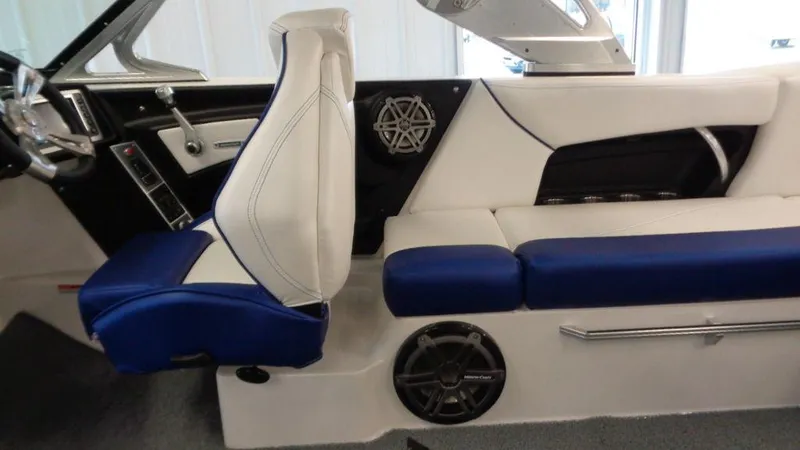Slide: The Image of 2017 MasterCraft X23 interior with white and blue seating, modern dashboard, and speaker system. - 9