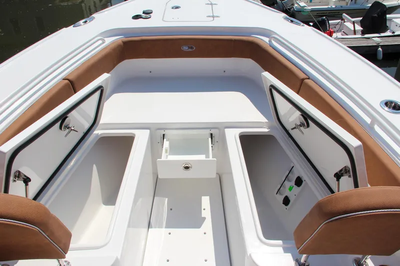 Slide: The Image of 2025 Sea Hunt Ultra 275 SE boat interior with open storage compartments. - 10