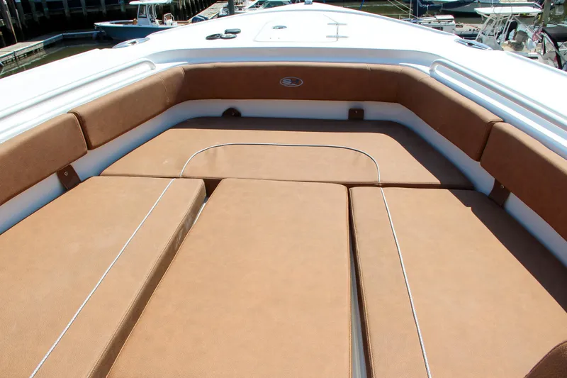Slide: The Image of 2025 Sea Hunt Ultra 275 SE boat with spacious cushioned seating area. - 11