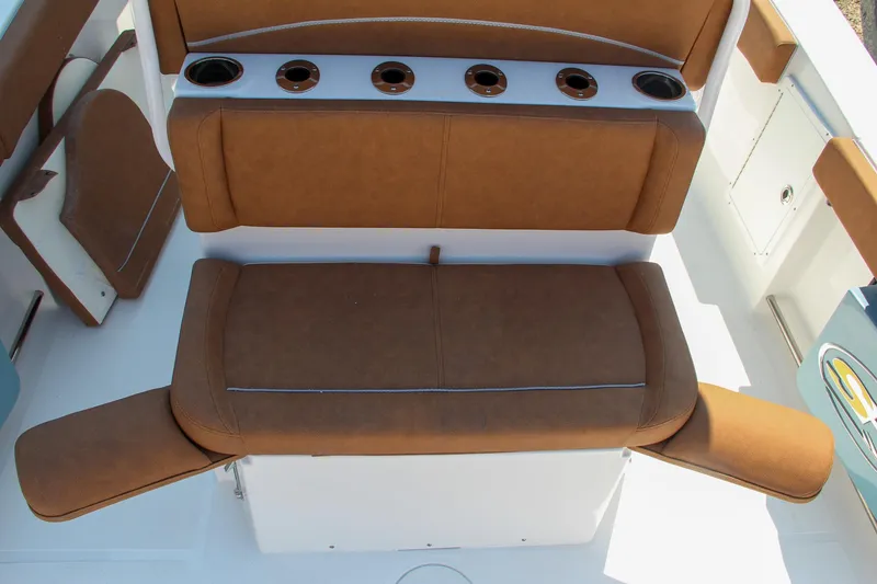 Slide: The Image of 2025 Sea Hunt Ultra 275 SE boat seating with cup holders and brown cushions. - 13