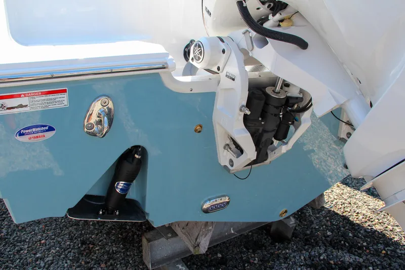 Slide: The Image of 2025 Sea Hunt Ultra 275 SE boat engine detail, featuring a sleek blue hull. - 14