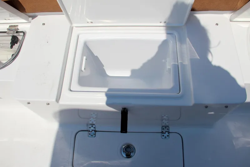 Slide: The Image of 2025 Sea Hunt Ultra 275 SE boat storage compartment with open lid. - 19