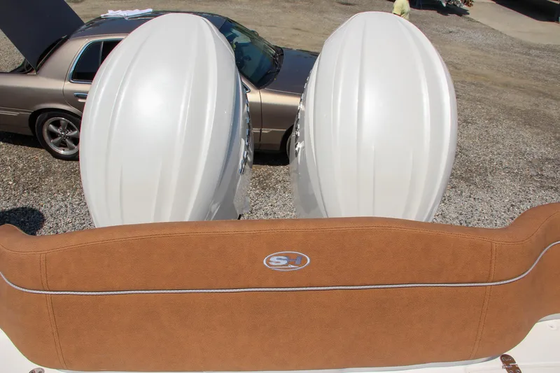Slide: The Image of 2025 Sea Hunt Ultra 275 SE boat with dual engines and tan seating. - 23