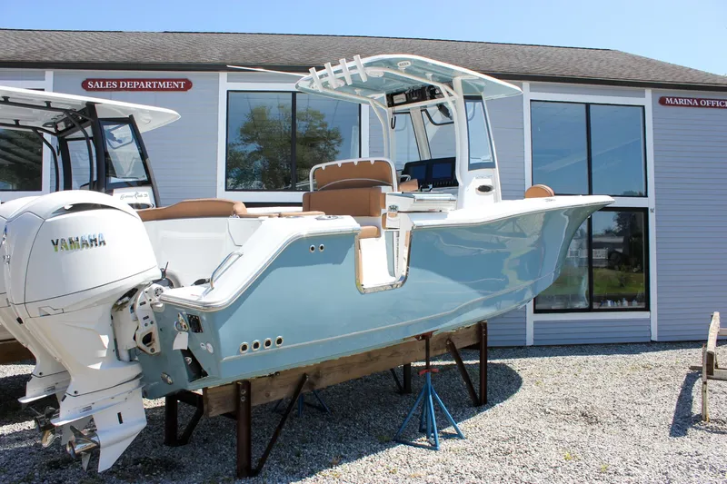 Slide: The Image of 2025 Sea Hunt Ultra 275 SE boat displayed outside sales department, featuring Yamaha engine. - 3
