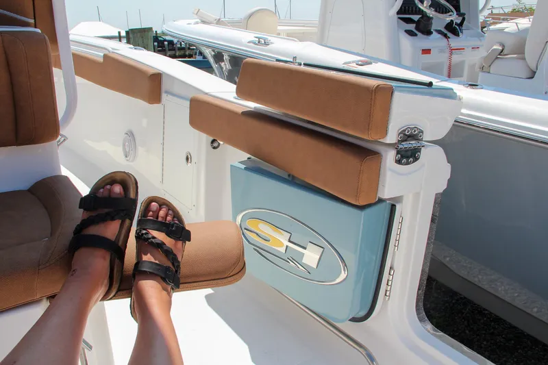 Slide: The Image of 2025 Sea Hunt Ultra 275 SE boat interior with cushioned seating and logo detail. - 30