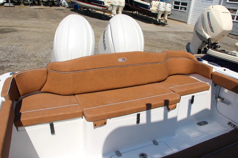 Slide: The Image of 2025 Sea Hunt Ultra 275 SE boat with tan seating and dual outboard motors. - 31