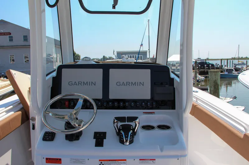 Slide: The Image of 2025 Sea Hunt Ultra 275 SE helm with dual Garmin displays at marina. - 33