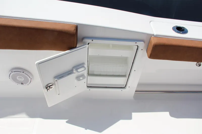 Slide: The Image of 2025 Sea Hunt Ultra 275 SE boat storage compartment with brown cushions. - 35