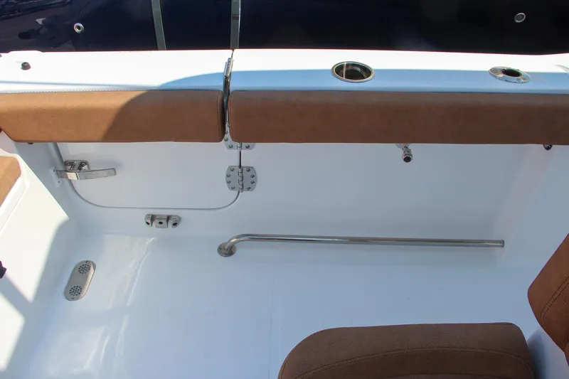 Slide: The Image of 2025 Sea Hunt Ultra 275 SE boat interior with brown seating and stainless steel fixtures. - 37