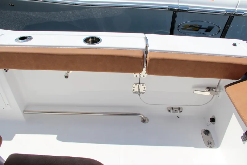 Slide: The Image of 2025 Sea Hunt Ultra 275 SE boat interior with brown seating and stainless steel fixtures. - 38