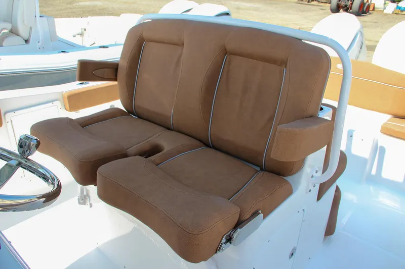 Slide: The Image of 2025 Sea Hunt Ultra 275 SE boat seating with brown cushions and white frame. - 40