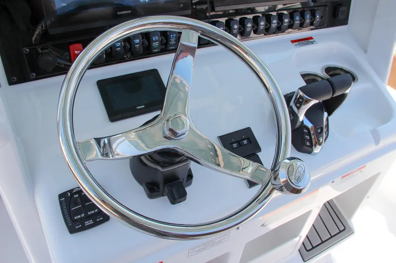 Slide: The Image of Steering console of 2025 Sea Hunt Ultra 275 SE boat with modern controls. - 42