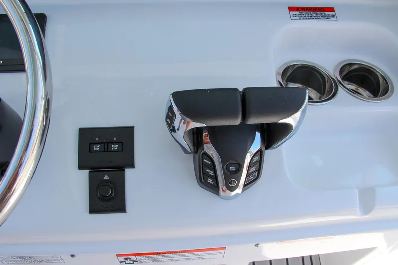 Slide: The Image of 2025 Sea Hunt Ultra 275 SE boat controls and cup holders. - 43
