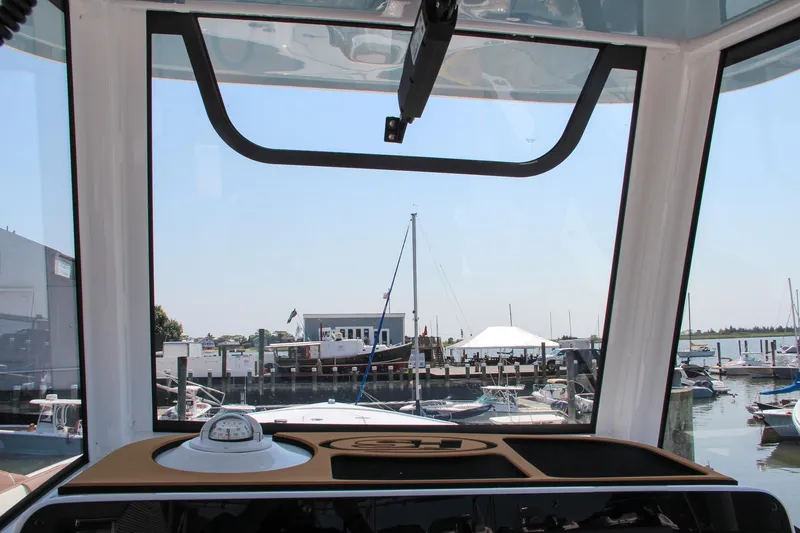 Slide: The Image of View from 2025 Sea Hunt Ultra 275 SE boat cockpit overlooking marina. - 44
