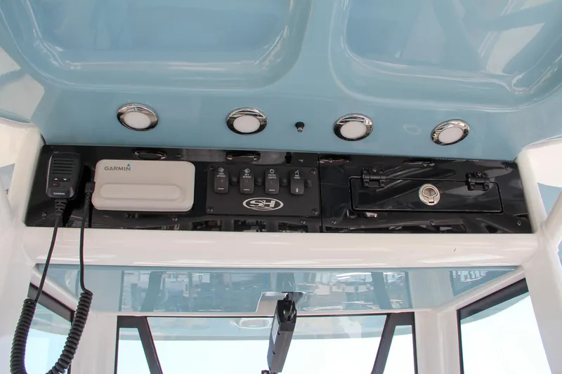 Slide: The Image of 2025 Sea Hunt Ultra 275 SE dashboard with Garmin electronics and controls. - 45