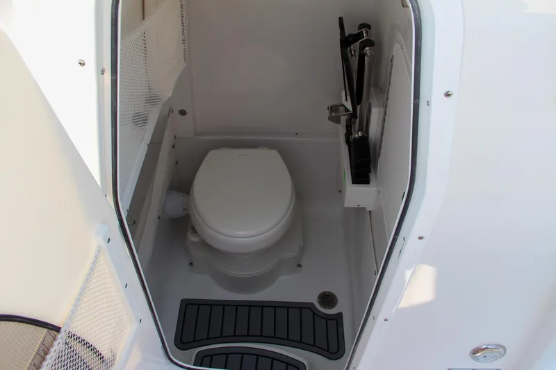Slide: The Image of 2025 Sea Hunt Ultra 275 SE boat interior with compact marine toilet. - 47