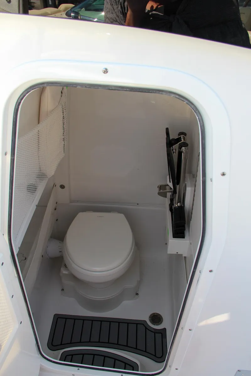 Slide: The Image of 2025 Sea Hunt Ultra 275 SE boat interior with compact marine toilet. - 48