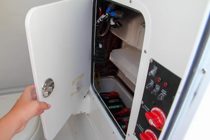 Slide: The Image of 2025 Sea Hunt Ultra 275 SE electrical panel and storage compartment. - 49