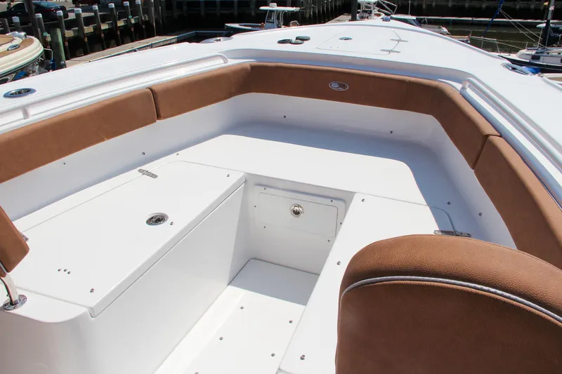Slide: The Image of 2025 Sea Hunt Ultra 275 SE boat interior with cushioned seating and storage compartments. - 50