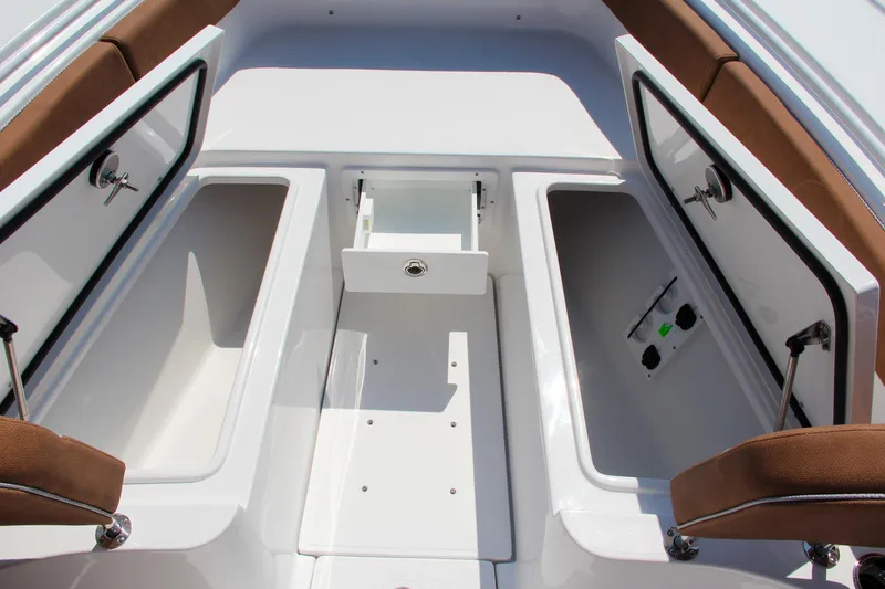Slide: The Image of 2025 Sea Hunt Ultra 275 SE boat storage compartments with brown seating. - 51