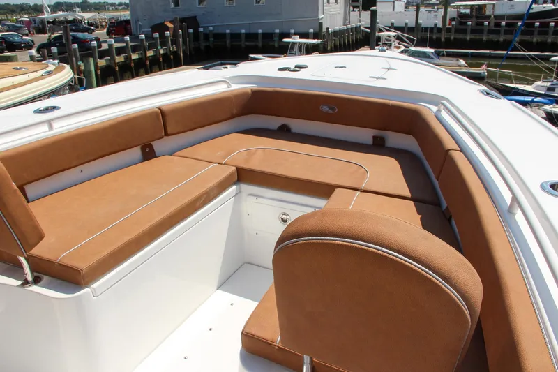 Slide: The Image of 2025 Sea Hunt Ultra 275 SE boat with tan seating in marina. - 52