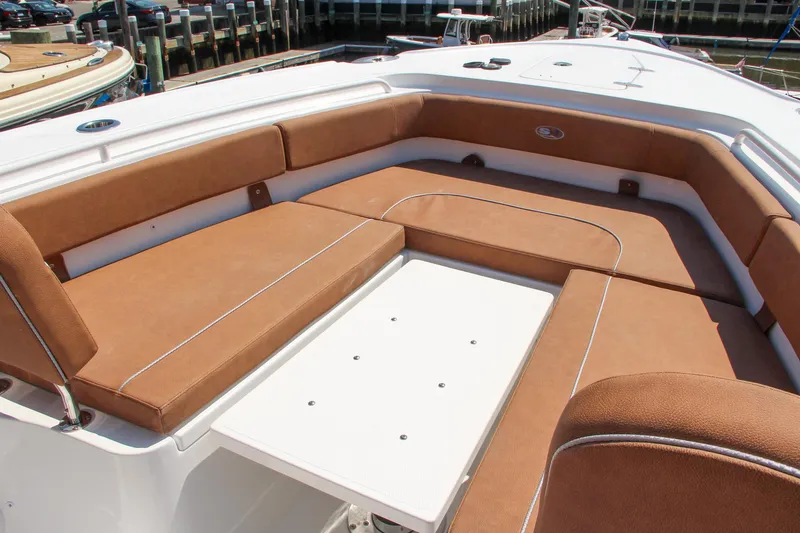 Slide: The Image of 2025 Sea Hunt Ultra 275 SE boat with spacious tan seating area. - 54