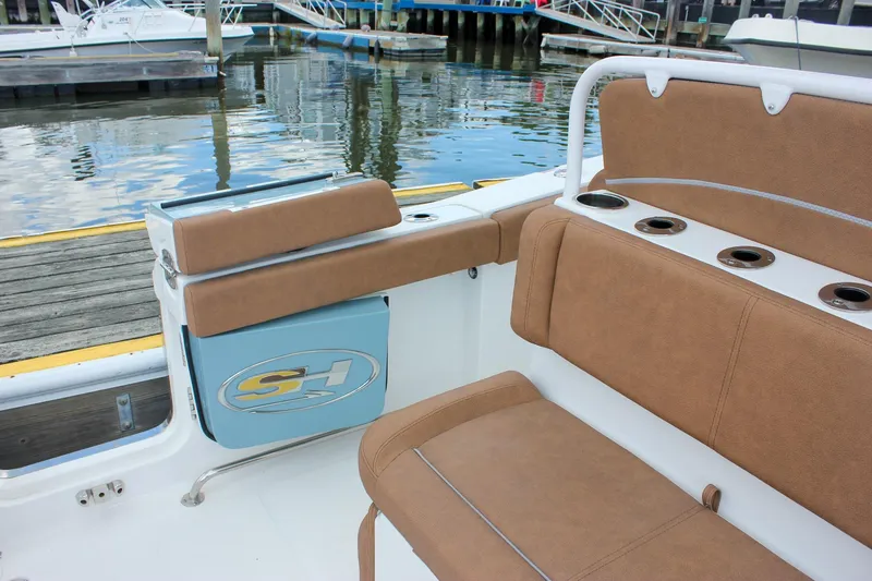 Slide: The Image of 2025 Sea Hunt Ultra 275 SE boat interior with tan seating and cup holders. - 6