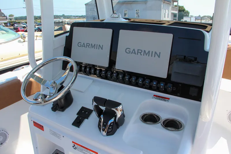 Slide: The Image of Sea Hunt Ultra 275 SE 2025 boat dashboard with dual Garmin displays. - 8