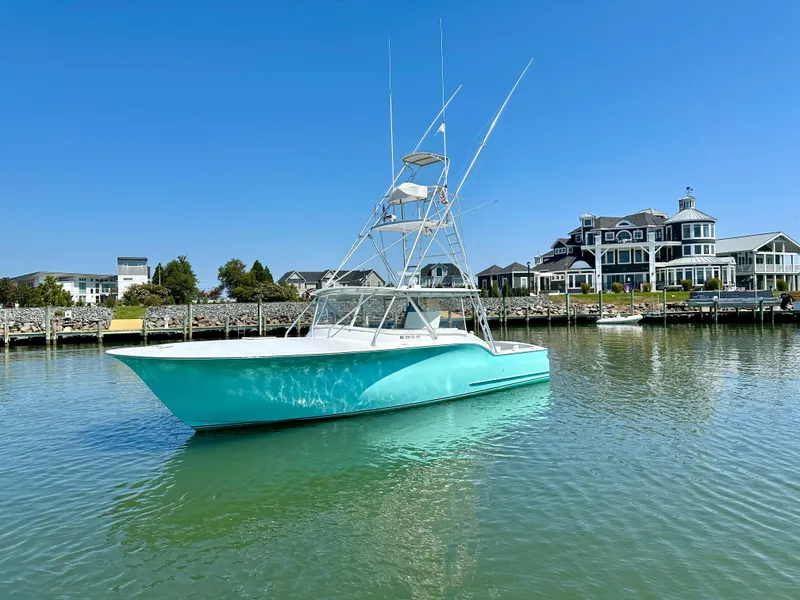 Slide: The Image of 2002 Custom Carolina 40 Express Sportfisherman in serene marina setting. - 10