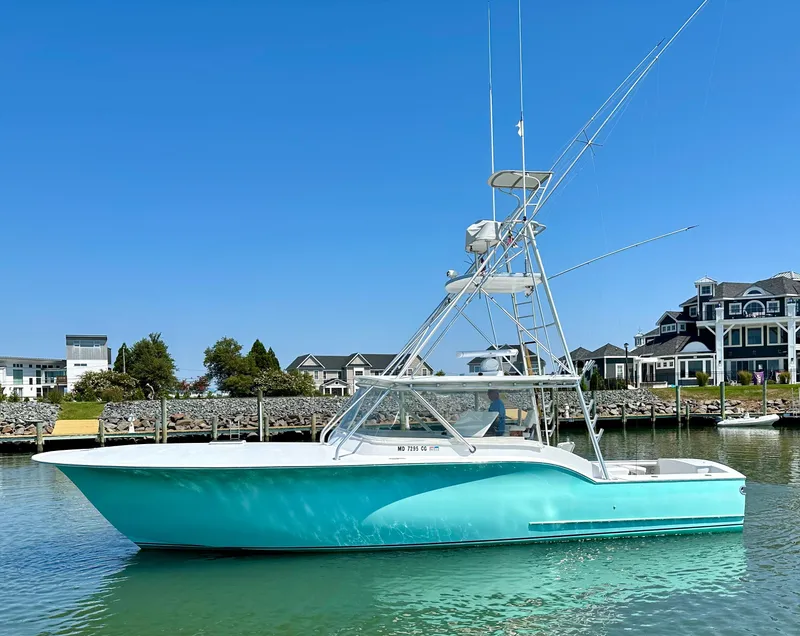 Slide: The Image of 2002 Custom Carolina 40 Express Sportfisherman in marina, clear sky background. - 13