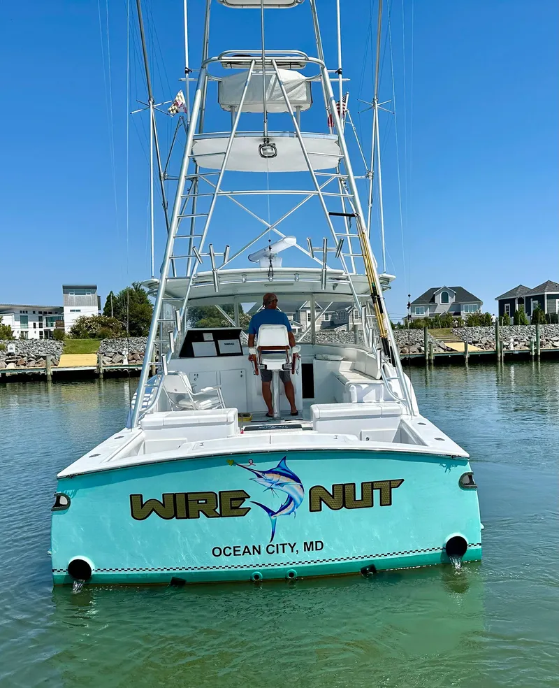 Slide: The Image of Custom Carolina 40 Express Sportfisherman, 2002, docked in Ocean City, MD, with "Wire Nut" branding. - 18
