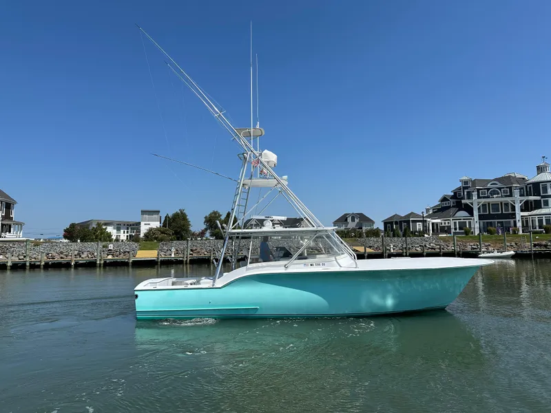 Slide: The Image of 2002 Custom Carolina 40 Express Sportfisherman in marina, clear sky background. - 2