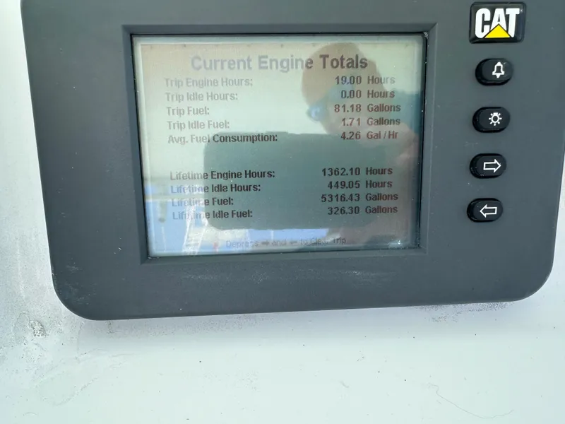 Slide: The Image of Engine monitor display showing fuel and hours for 2002 Custom Carolina 40 Express Sportfisherman. - 23