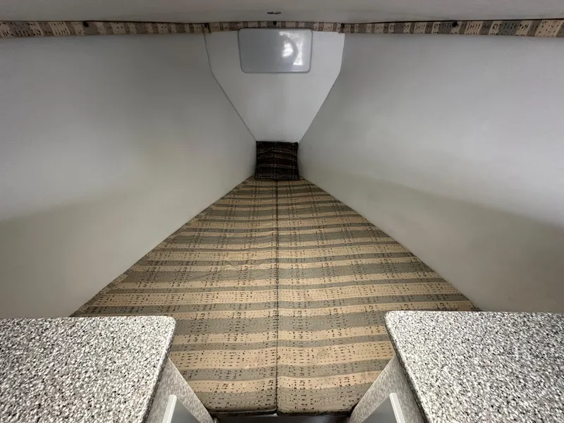 Slide: The Image of Interior cabin of 2002 Custom Carolina 40 Express Sportfisherman with patterned bedding. - 24