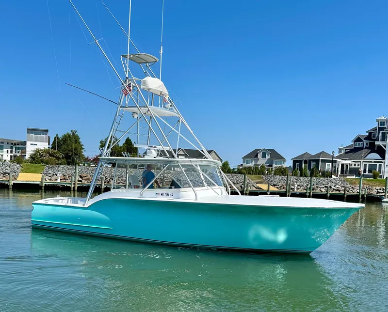 Slide: The Image of 2002 Custom Carolina 40 Express Sportfisherman in marina, clear sky, waterfront homes. - 3