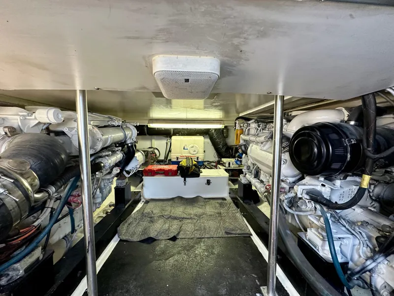 Slide: The Image of Engine room of 2002 Custom Carolina 40 Express Sportfisherman, showcasing dual engines and equipment. - 31