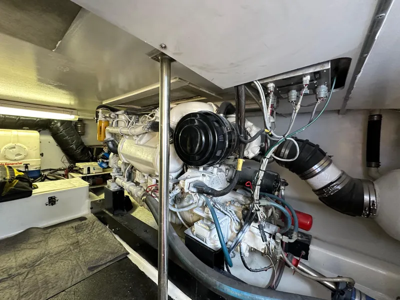 Slide: The Image of Engine room of 2002 Custom Carolina 40 Express Sportfisherman, showcasing detailed machinery and components. - 33