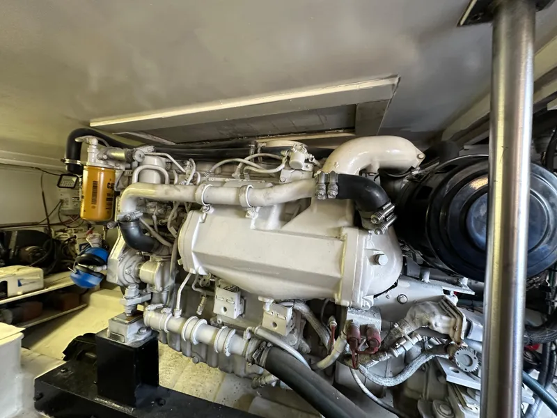 Slide: The Image of Engine room of 2002 Custom Carolina 40 Express Sportfisherman, showcasing detailed machinery components. - 34