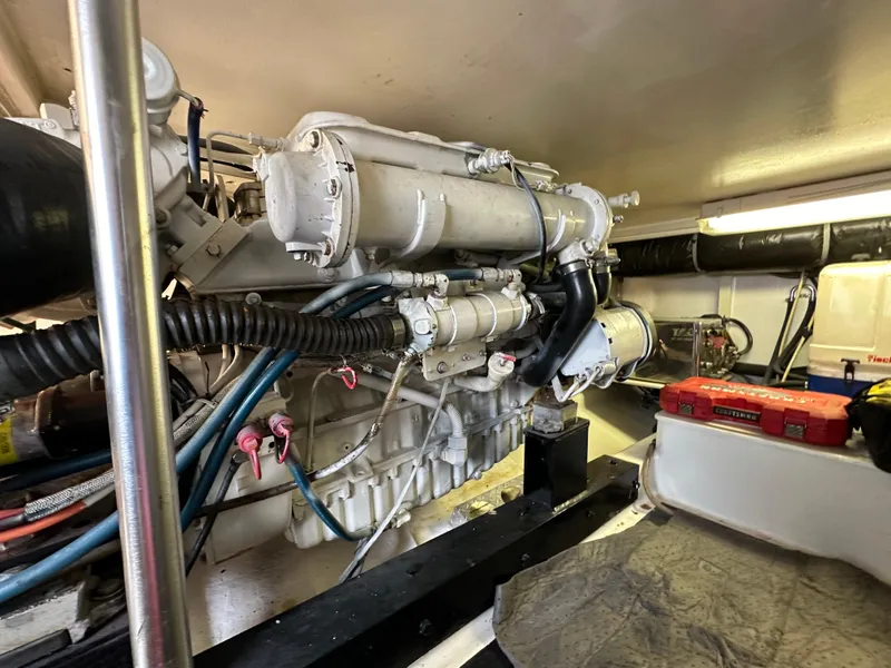 Slide: The Image of Engine room of 2002 Custom Carolina 40 Express Sportfisherman, showcasing detailed machinery and components. - 35